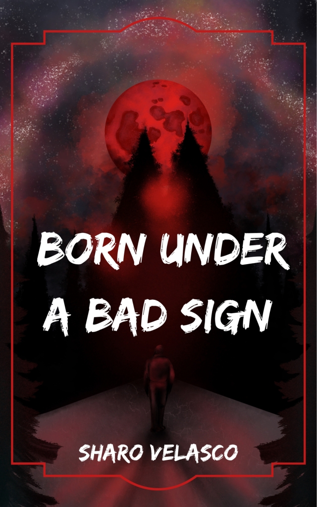 ebook cover of a dark forest road bathed in red light from the blood red full moon and red galaxy arching over the sky as a lone figure walks away from the viewer. there is a decorative red border around the image. in white all caps font it reads "Born Under A Bad Sign" in the middle of the image, and in a smaller all caps font it reads the author name, "Sharo Velasco" at the bottom